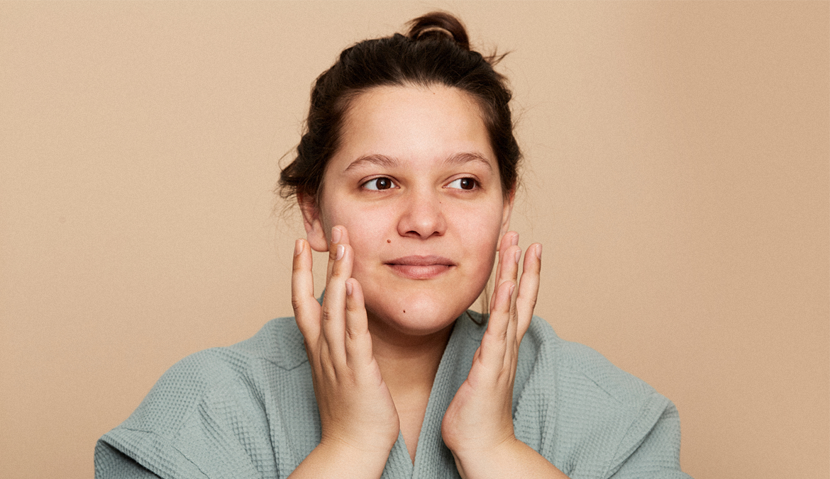 dermatology patient rubbing her face