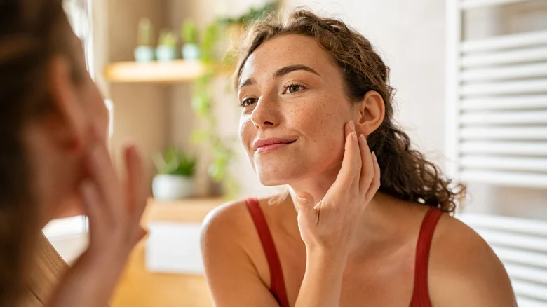 woman looking at her face | Geria Dermatology