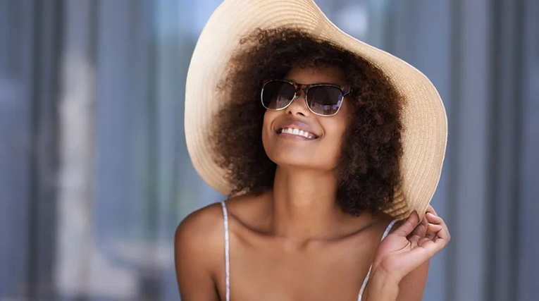 woman in a big hat and sunglasses geria dermatology