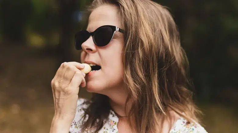 Woman eating raw garlic
