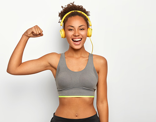 Woman flexing with nice body | Geria Dermatology